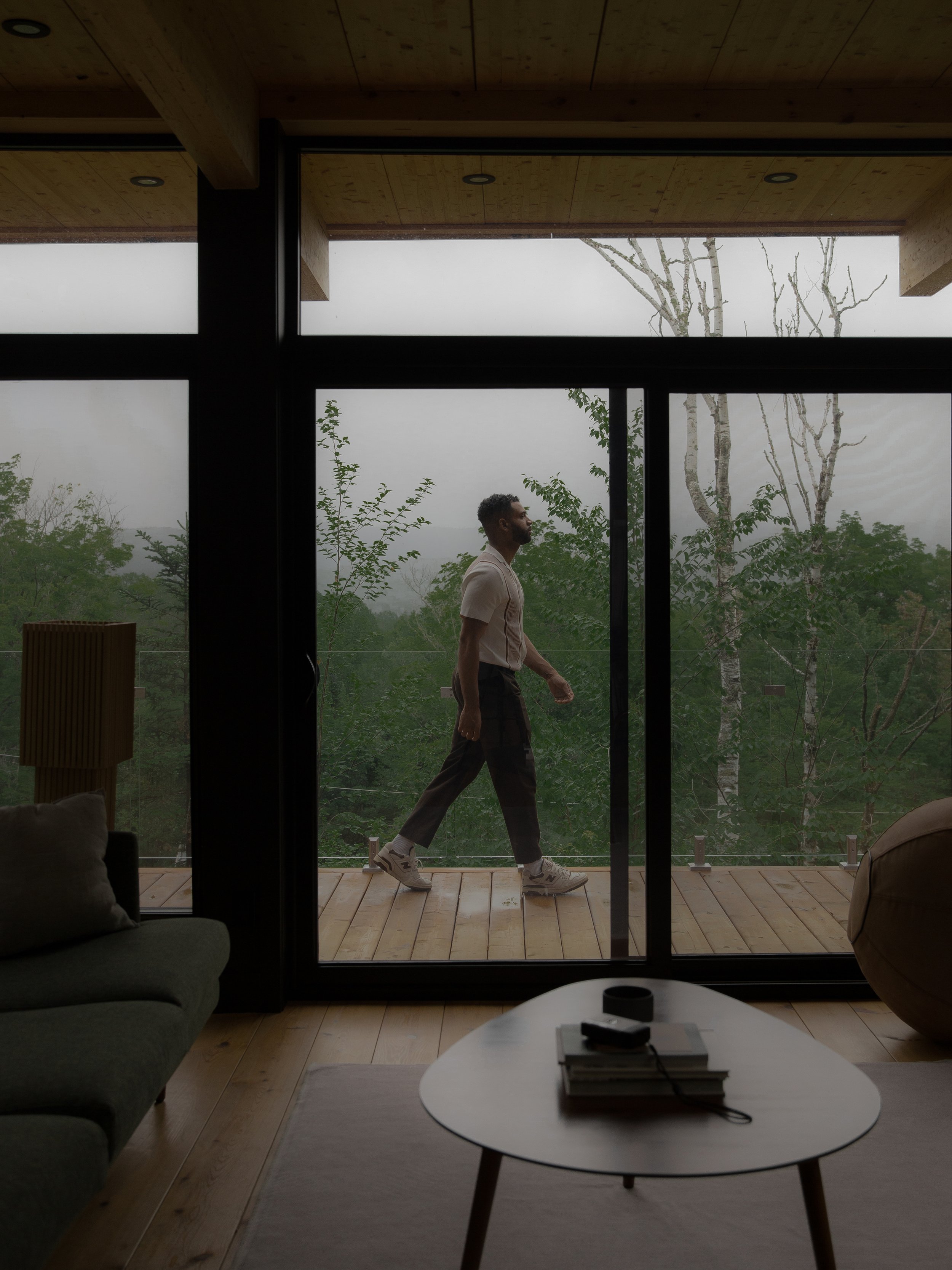 a guest stepping onto the balcony of a hinter space in the fog