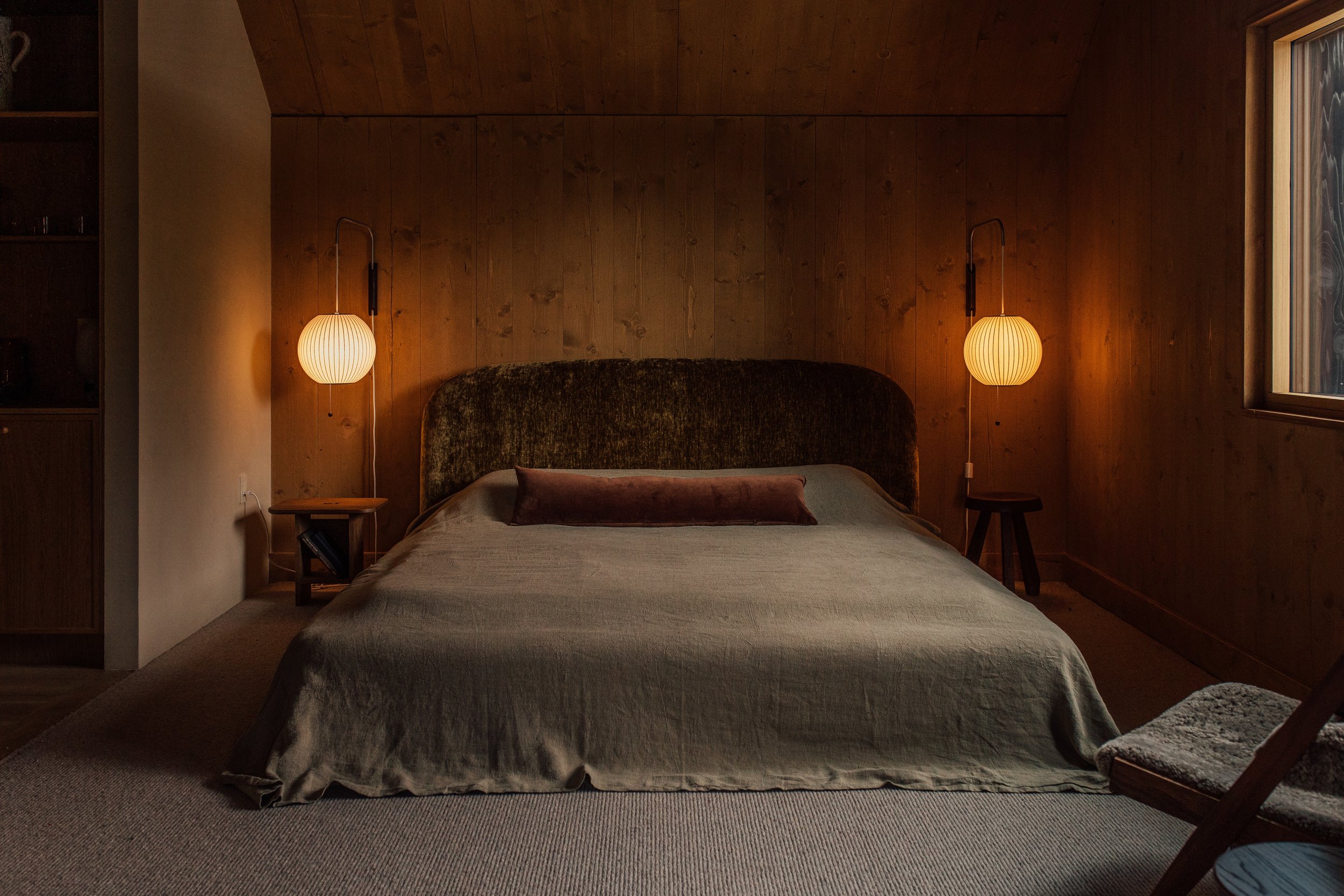 a quiet corner of a hinter interior with natural light across timber walls